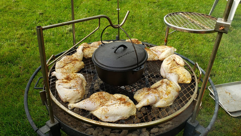 Chicken on a grill with a Dutch Oven